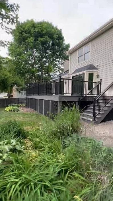 Dark raised deck and stairs with black railings
