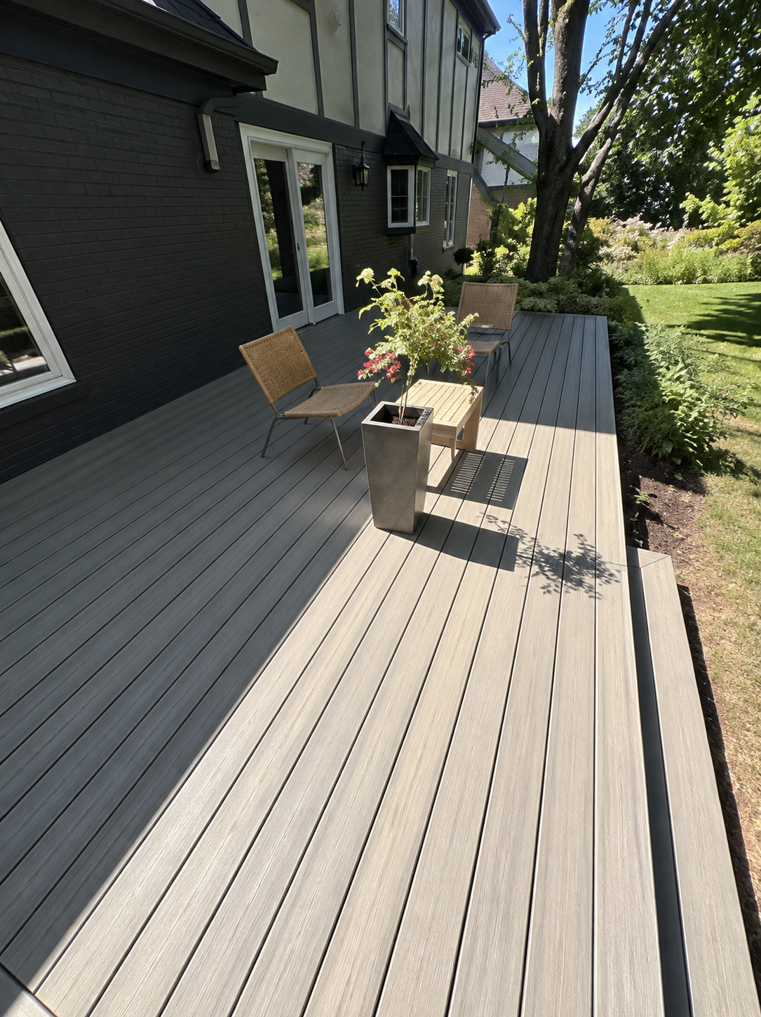 Long gray deck running alongside a home