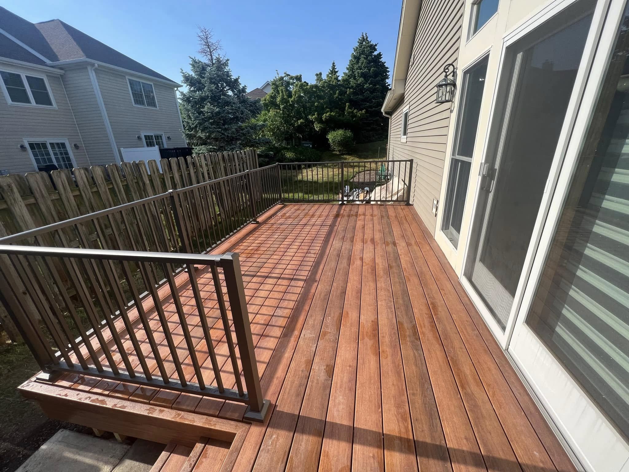 View along the new wood deck beside the home’s sliding glass door